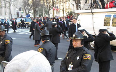 Washington D.C., USA-January 21, 2013:  President Barack Obama steps out and waves to the crowd on Pennsylvania Avenue in Washington D.C. for his inauguration.  This is the last time he will be seen in an inaugural parade.